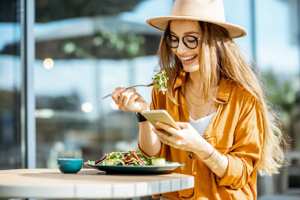 Woman eating salad on a cafe terrace